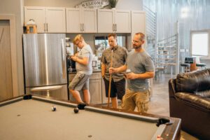pool table with stairs and retro games in back