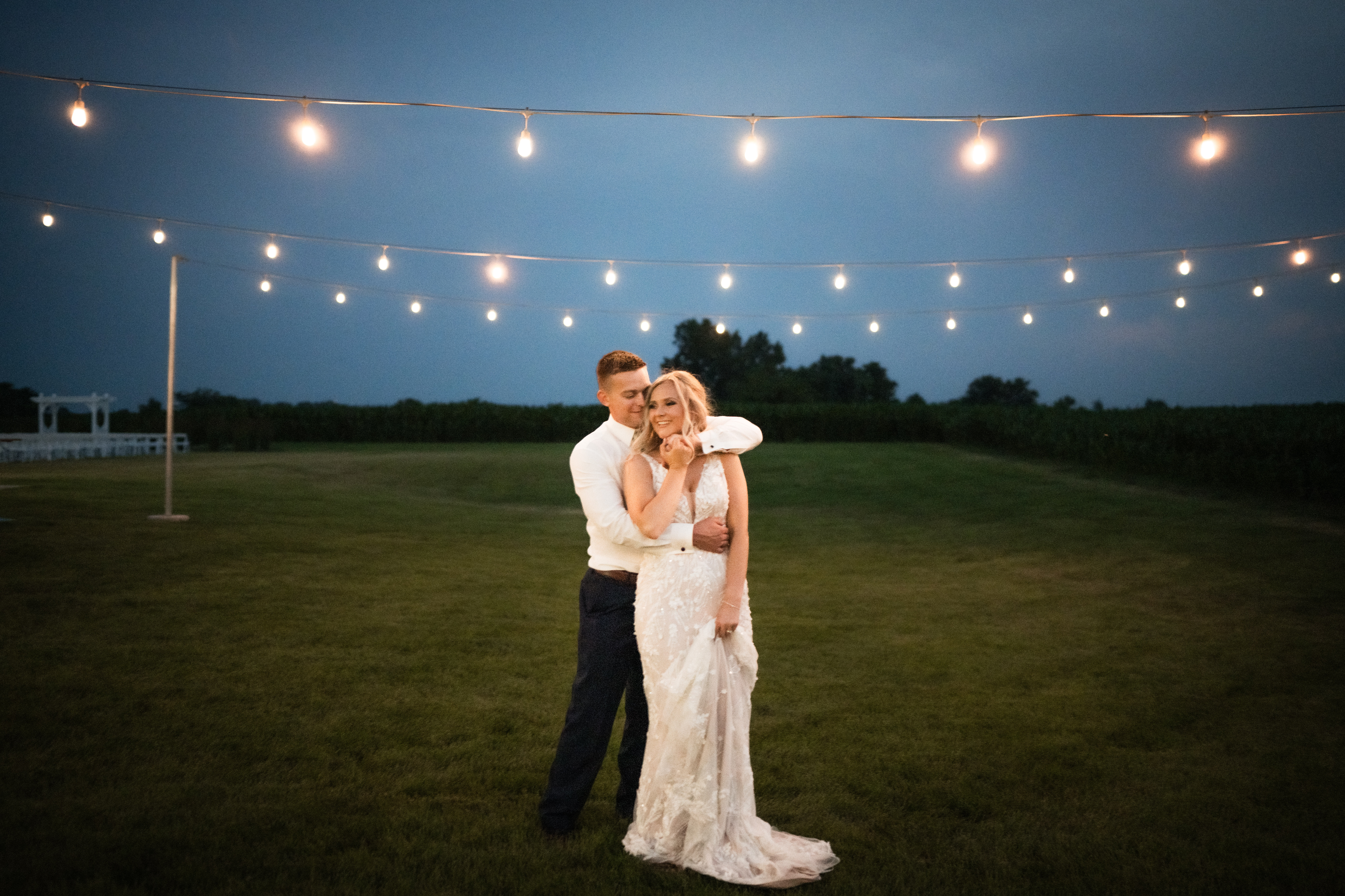Elegant wedding celebration at Fairview Acres Barn outside lights