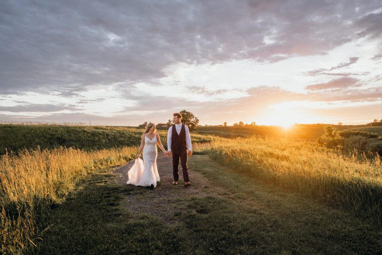 Bride and groom captured during a golden hour photo session by the pond at Stress-Free Weddings Fairview Acres Barn.
